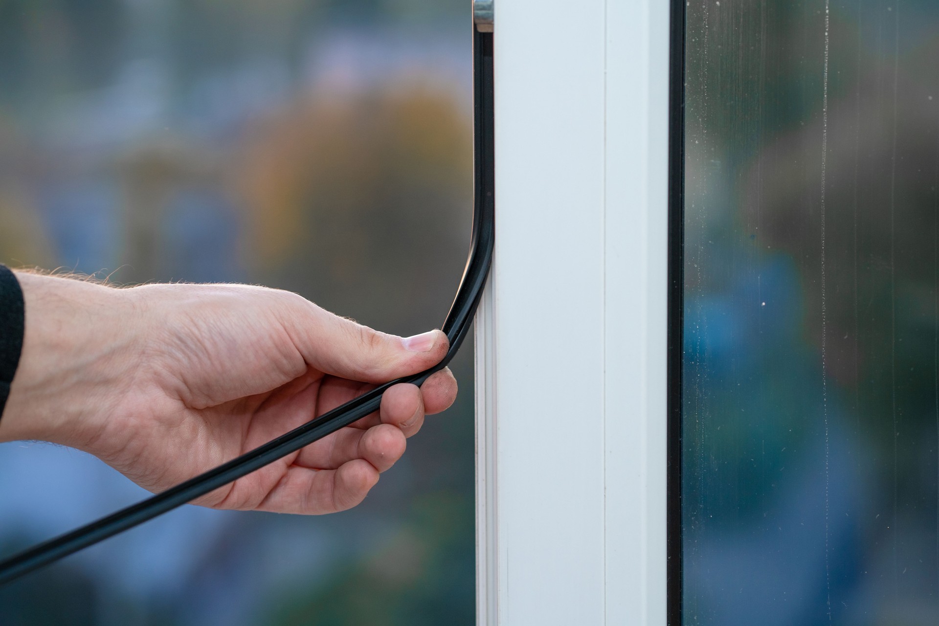 Professional master at repair and installation of windows, changes rubber seal gasket in pvc windows